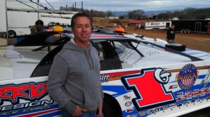 Rick Eckert beside the Warrior House car he will drive over the next two weekends.
