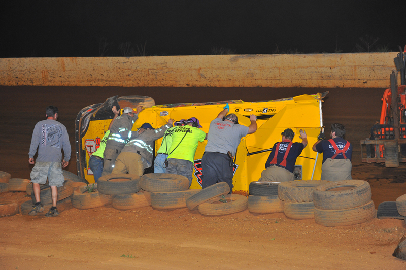 Tommy Kerr's wrecked race car is overturned to its upright position. 