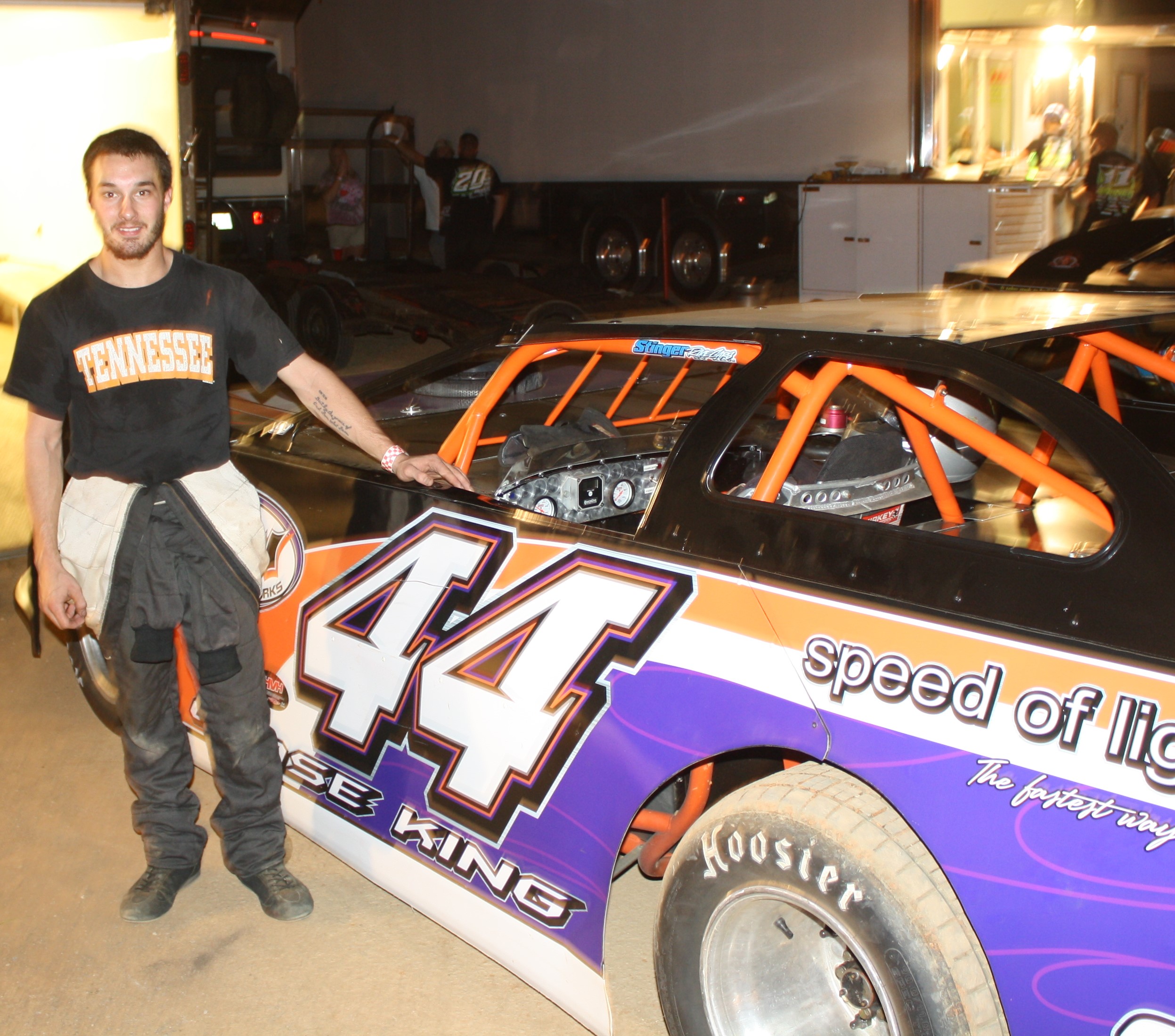 Chase King standing beside the Crate Late Model he recently won with at 411.