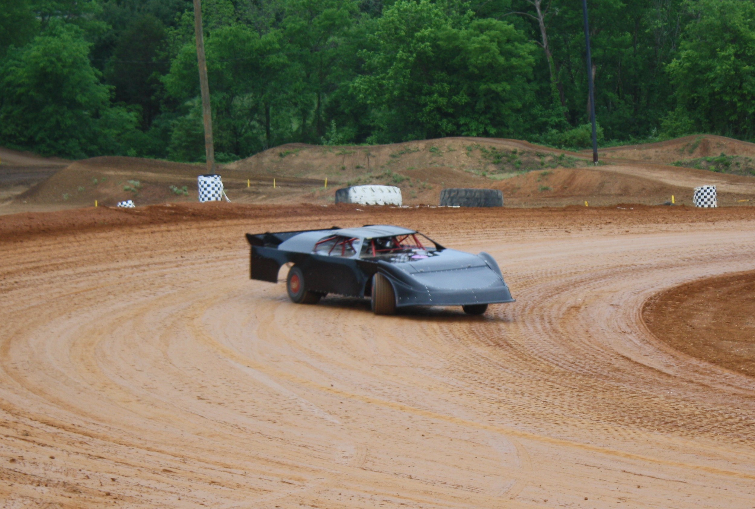 The Late Model of Brian Hooks' Late Model negotiates the east end of the new I-40 Raceway. 