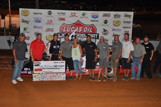 Sara McDowell joins her husband and brother-in-law in victory lane.