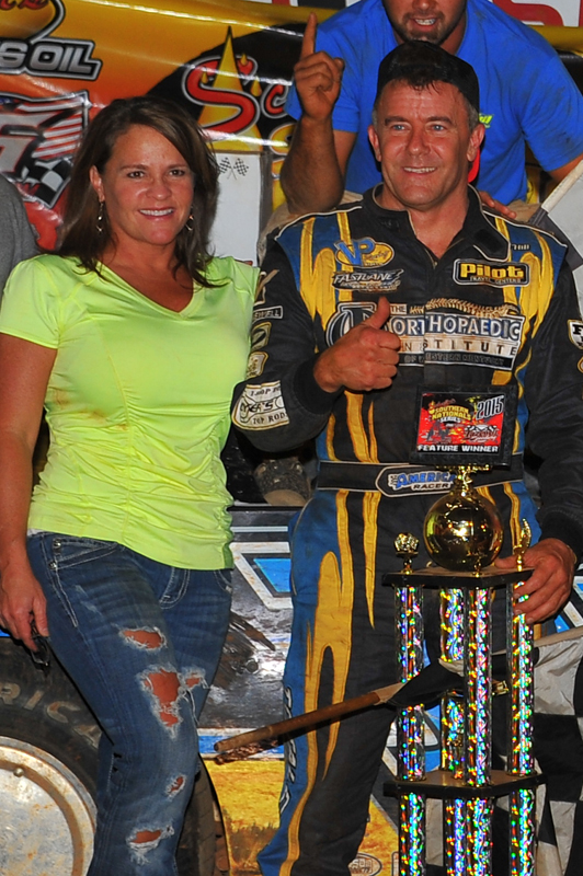 Christa Hill joins her husband in victory lane